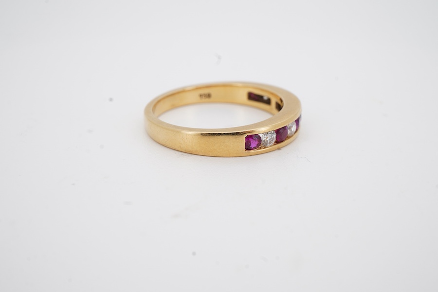 A recent 18k yellow metal, six stone ruby and five stone diamond set half hoop ring, size N, gross weight 3.8 grams.